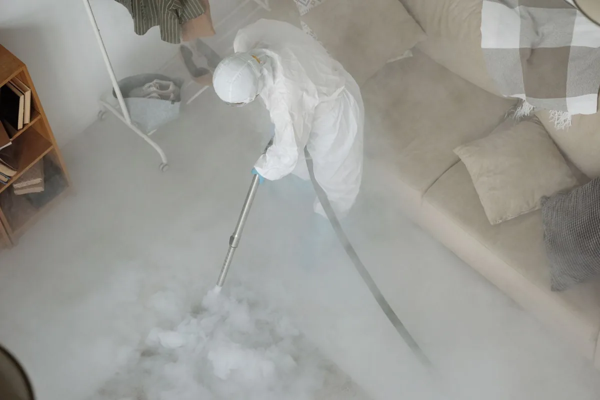 Biohazard cleanup technician in protective equipment, Laton, CA